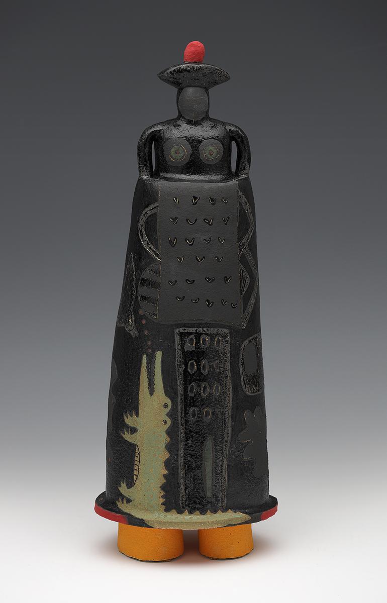 Dark figure in red-topped hat with alligator climbing