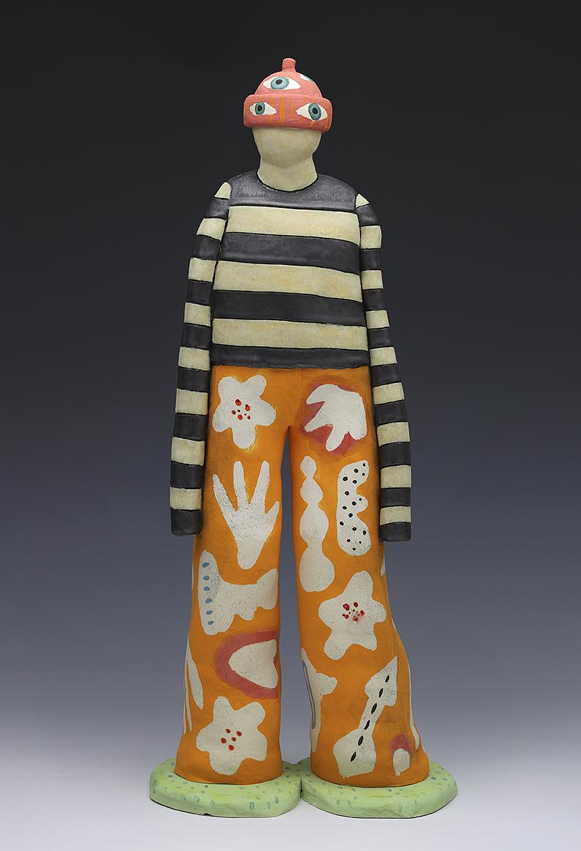Figure in striped shirt, decorative pants and hat with eyes