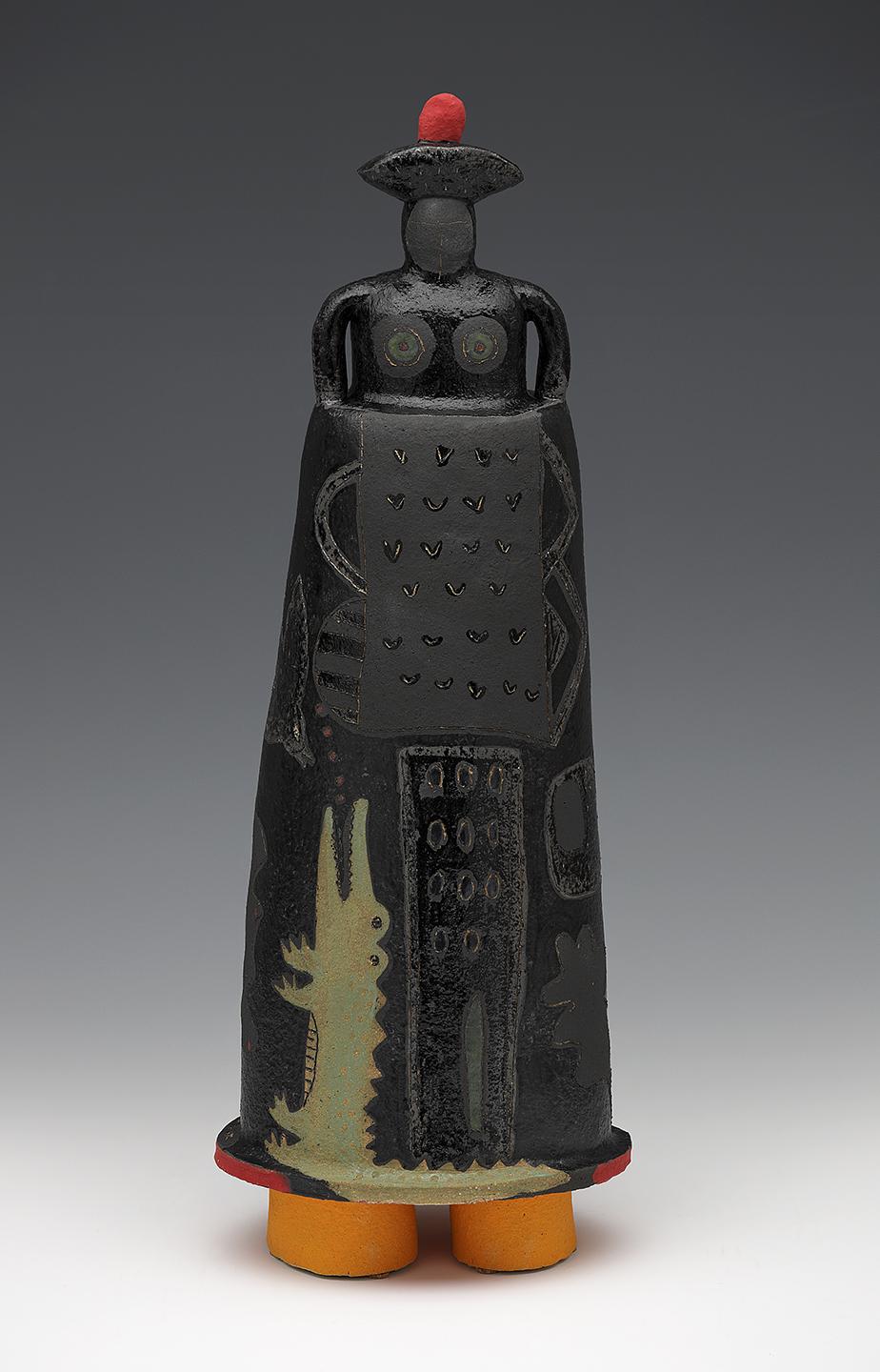 Dark figure in red-topped hat with alligator climbing