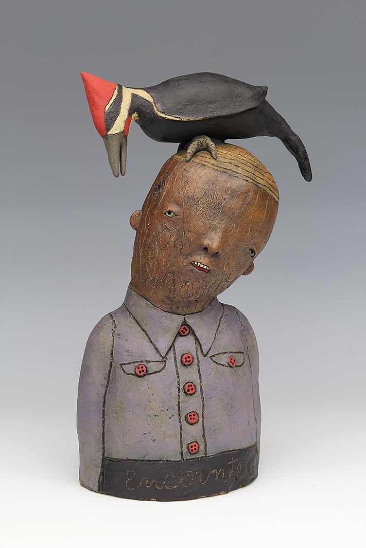 ceramic sculpture with pileated woodpecker bird by sara swink